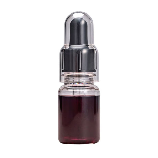 Glitch Oil EVO-2000 in a small clear bottle of dark red oil with a black dropper cap under a clear cover, on a white background